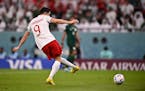 Poland’s Robert Lewandowski scores his side’s second goal during the World Cup group C soccer match between Poland and Saudi Arabia, at the Educat