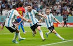 Argentina’s Lionel Messi celebrates with teammates after scoring his side’s first goal during the World Cup group C soccer match between Argentina