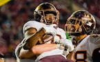 Gophers wide receiver Le’Meke Brockington, left, celebrated with tight end Brevyn Spann-Ford after catching the winning 45-yard touchdown pass again