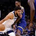 Wolves center Karl-Anthony Towns tried to drive on Warriors forward JaMychal Green in the first quarter at Target Center on Sunday.