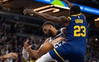 Minnesota Timberwolves center Rudy Gobert (27) lost control of the ball while defended by Golden State Warriors forward Draymond Green (23) in the fir