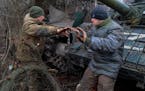 Servicemen of the People’s Militia of Russian-controlled Donetsk region repair a T-72 tank damaged in fighting between Russian and Ukrainian forces,