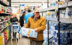 John Beezley, of Bonham, buys cases of water after learning that a boil water notice was issued for the entire city of Houston on Sunday, Nov. 27, 202