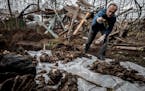 A forensic expert exhumes bodies that showed indications of having been executed from a communal grave in Pravdyne, a village near Kherson, Ukraine, o