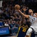 Timberwolves center Rudy Gobert (27) went up for a layup against Golden State forward Draymond Green on Sunday at Target Center.