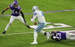 Andrew Booth Jr. of the Vikings held on to the right leg of Cowboys quarterback Dak Prescott when the teams met two weeks ago.
