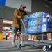 John Beezley, of Bonham, carts out several cases of water after learning that a boil water notice was issued for the entire city of Houston on Sunday,