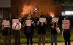 Protesters hold up white paper some with writings commemorating the Nov 24 deadly Urumqi fire during a gathering at the University of Hong Kong in Hon
