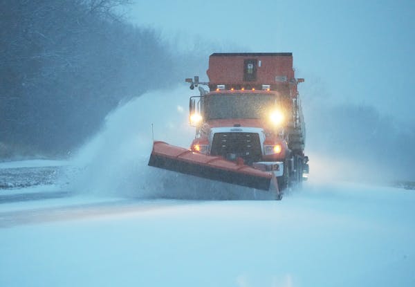 A snowplow pushes fresh snow from McAndrews Road on Tuesday morning in Apple Valley.