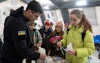 A rescue worker makes tea for children at the heating tent “Point of Invincibly” in Bucha, Ukraine, Monday, Nov. 28, 2022.