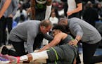 Timberwolves head athletic trainer Gregg Farnum, left, attended to Karl-Anthony Towns on Monday night in Washington.