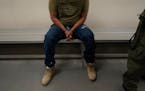 An immigrant considered a threat to public safety and national security waits to be processed by U.S. Immigration and Customs Enforcement agents at th