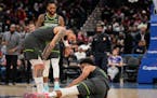 Wolves guard Austin Rivers checked on teammate Karl-Anthony Towns on Monday after Towns was injured in a game in Washington.