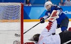 Jocelyne Lamoureux-Morando shot the puck past Canada goalie Shannon Szabados (1) during the gold medal game shootout at the Pyeongchang Olympics on Fe