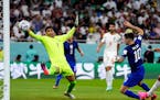 Christian Pulisic of the United States scores past Iran goalkeeper Alireza Beiranvand on Tuesday during a World Cup Group B match. The Americans advan