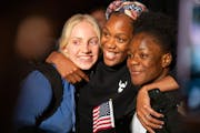 Brooklyn Hays, Precious Wieser and Nina Makem, from left, posed for photos after a naturalization ceremony Tuesday at St. Paul RiverCentre. Makem, who