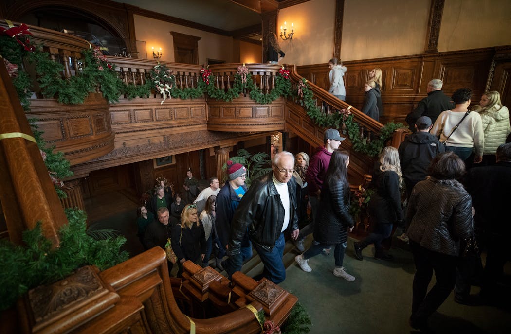 A tour group looked over the grand staircase at the James J. Hill House in 2019.