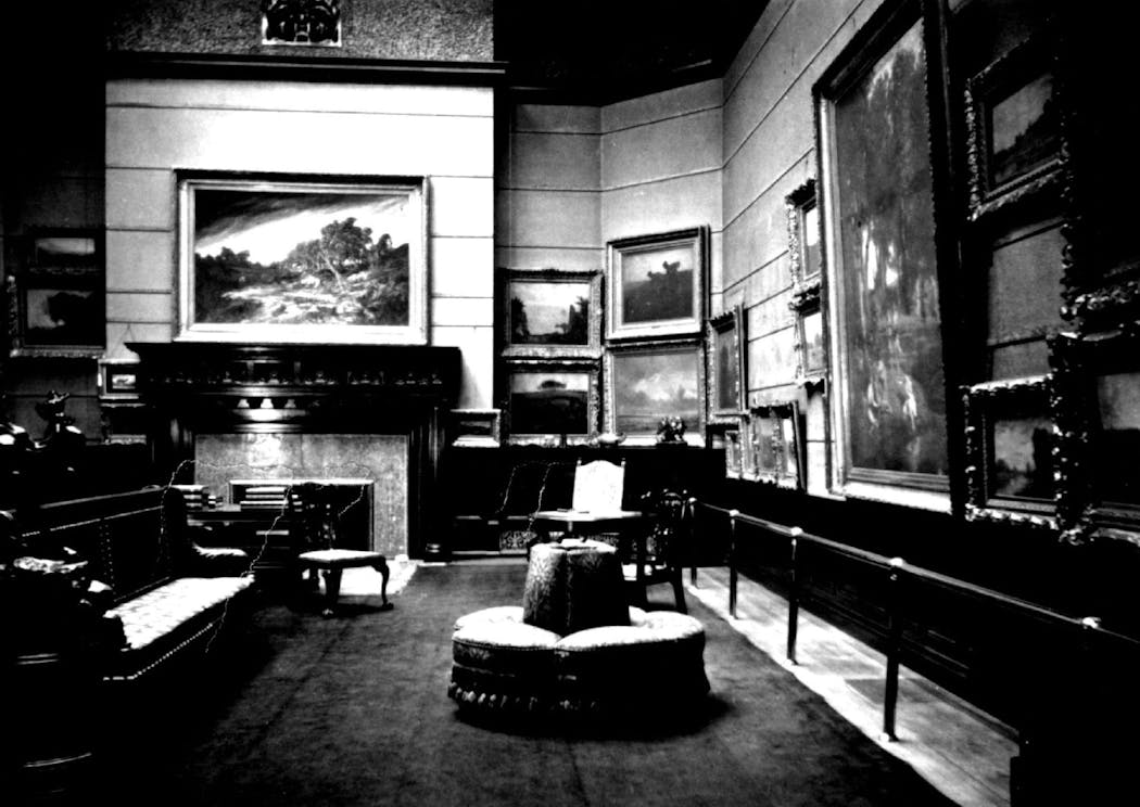 Ornately framed pictures in the art gallery, seen in the early 1900s.