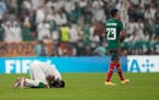 Saudi Arabia’s Firas Al-Buraikan, left, and Mexico’s Jesus Gallardo react at the end of the World Cup match between their countries.