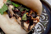 Charred tofu topped with chili crisp and herbs is stuffed inside a fluffy bun at Abang Yoli.