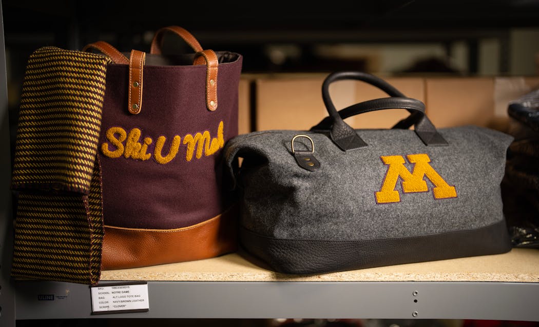 A wool tote and overnight bag with University of Minnesota branding in the Heritage Gear warehouse in Edina, Minn. 