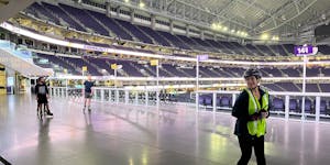 Lee Engele, lead skate guard at U.S. Bank Stadium, cheers on the hardy souls who trudged through the snow for the opening night of Winter Warm-Up. On 