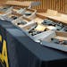 Confiscated guns used in statewide crimes are displayed on a table inside the Bureau of Criminal Apprehension offices in July in St. Paul.