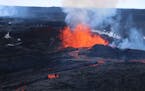 This aerial image courtesy of Hawaii Dept. of Land and Natural Resources shows lava flows on Mauna Loa, the world’s largest active volcano, on Wedne