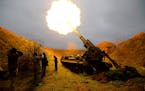 A Ukrainian Pion self-propelled cannon fires toward a Russian ammunition depot across the Dnieper River in Ukraine’s southern Kherson region on Thur