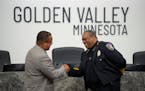 Virgil L. Green, Sr. was congratulated after he was sworn in as the new police chief of Golden Valley by Minnesota Attorney General Keith Ellison in a
