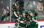 Minnesota Wild center Sam Steel (13) was flanked by linemates right wing Mats Zuccarello (36) and left wing Kirill Kaprizov (97) as they celebrated hi