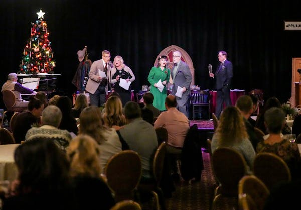 Actors perform in the radio production of “It’s a Wonderful Life” during a private holiday party hosted by Summit Mortgage for the staff of the 