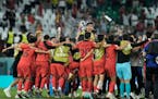 South Korea’s players celebrate at the end of the World Cup match vs. Portugal.,
