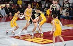 Minnesota Gophers center Treyton Thompson (42) puts a hand on the ball held by Purdue Boilermakers center Zach Edey (15) and is called for a foul duri