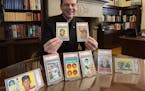 Fr. John Ubel with some of his childhood Baseball cards auctioned in 2021 to fund scholarships to help students to attend Catholic grade schools.