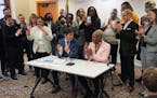 Flanked by supporters and City Council President Andrea Jenkins, Mayor Jacob Frey signed on Friday an executive order that protects people seeking or 