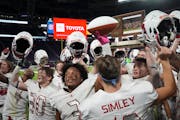 Simley teammates celebrated near the fan section to celebrate after defeating Hutchinson 34-24 in the Class 4A championship game at the Prep Bowl at U