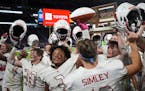 Simley teammates celebrated near the fan section to celebrate after defeating Hutchinson 34-24 in the Class 4A championship game at the Prep Bowl at U