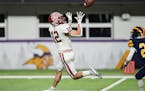 Maple Grove Crimson wide receiver Jacob Anderson (12) caught a pass to then run for a touchdown in the first half against Rosemount.