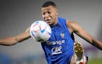 France’s Kylian Mbappe controls the ball during a training session at the Jassim Bin Hamad stadium in Doha, Qatar, Friday, Dec. 2, 2022.