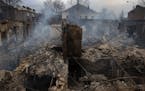 A smoldering building in the frontline city of Bakhmut, Ukraine, where remaining residents are living in basement shelters and relying on volunteers f