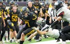 New London-Spicer’s Mason Delzer (7) tries to break a tackle in the first half in the Minnesota High School football Class 3A State Championship at 
