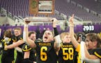 New London-Spicer celebrates with the champion trophy held by Gabe Rohman (6) in the Minnesota High School football Class 3A State Championship at U.S