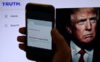 In this photo illustration, the suspended Twitter account of former U.S. President Donald Trump is displayed on a mobile phone with former U.S. Presid