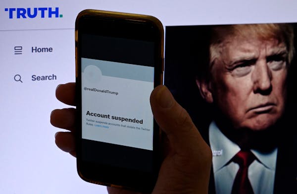 In this photo illustration, the suspended Twitter account of former U.S. President Donald Trump is displayed on a mobile phone with former U.S. Presid