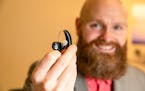 Sterling Sheffield, an assistant professor of Speech, Language, and Hearing Sciences at the University of Florida, holds an over-the-counter hearing a