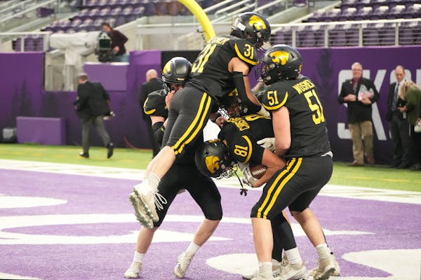 New London-Spicer players celebrate in the end n zone after Brycen Christensen (81)   scored the touchdown to win the 3A title game over Dilworth-Glyn