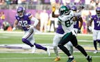 Minnesota Vikings safety Harrison Smith (22) runs from New York Jets tight end Tyler Conklin (83) after intercepting a pass during the first half of a