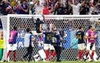 France’s Marcus Thuram, top, jumps to crossbar as his team members celebrate after the World Cup round of 16 soccer match between France and Poland,
