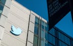 A Twitter logo hangs outside the company’s San Francisco offices on Nov. 1, 2022.